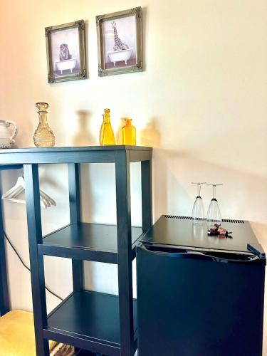 a blue table with a shelf with vases on it at Gasterij Hotel Dennenoord in Boxtel