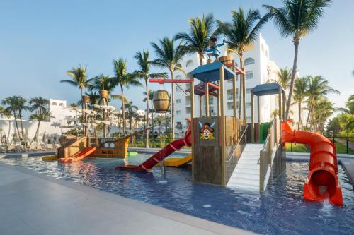 a swimming pool with slides and slidesktop at Riu Flamingos - All Inclusive in Nuevo Vallarta