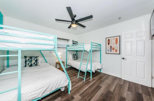 a bedroom with two bunk beds and a ceiling fan at Hidden Gem 3 Bedroom Home in Largo