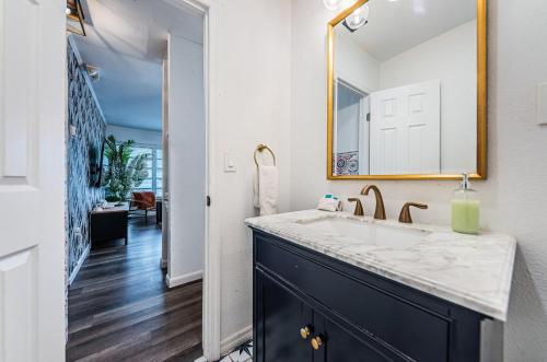 a bathroom with a sink and a mirror at Hidden Gem 3 Bedroom Home in Largo