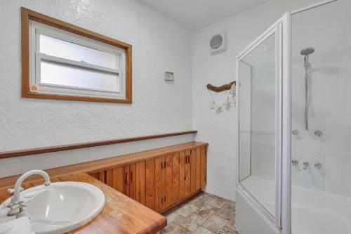 a bathroom with a sink and a shower at Aloha Amity in Amity Point