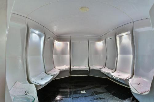 an empty aisle of an airplane with pink seats at Sofitel Al Khobar The Corniche in Al Khobar