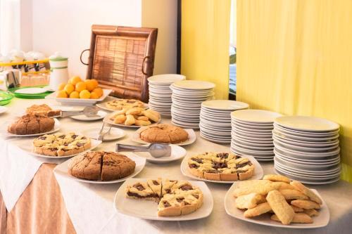 a table topped with plates and cookies on plates at Hotel Mignon Riccione Fronte Mare in Riccione