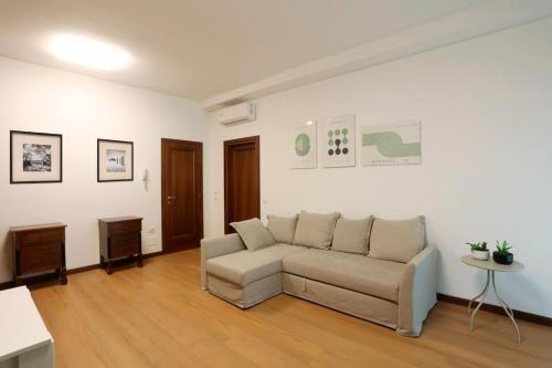 a living room with a couch and a table at Solferino Green - Modern Stay - Near station in Brescia