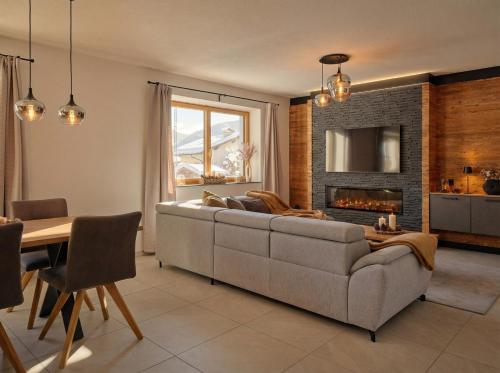 a living room with a couch and a fireplace at Lodge am Wetterstein in Ehrwald