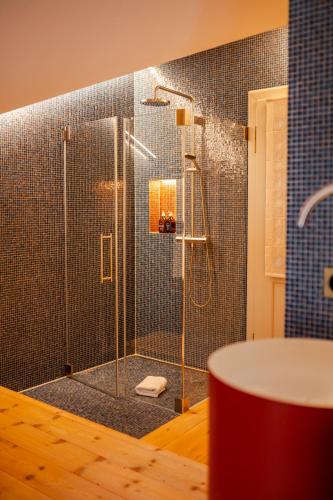 a shower with a glass door in a bathroom at Villa Klainguti in Pontresina