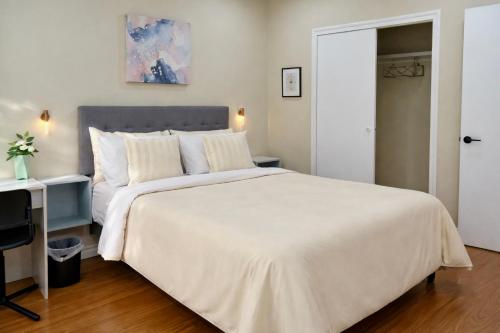 a bedroom with a large white bed and a desk at Vita House - Minutes to Rogers Stadium - Walk or Transit - Near VELD Downsview and Yorkdale in Toronto