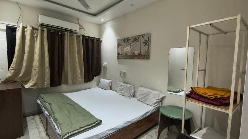 a small room with a bed and a mirror at Hotel flexistays central dhantoli in Dhantoli