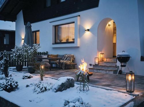 a living room with a fire in the snow at Lodge am Wetterstein in Ehrwald