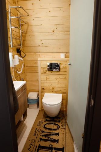a wooden bathroom with a toilet and a sink at Zelemin House in Skole