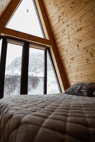 a bedroom with a bed and a large window at Zelemin House in Skole
