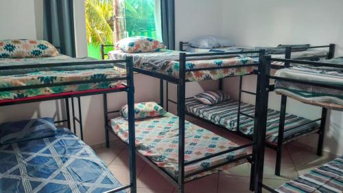 a group of bunk beds in a room at Hostel Sundays in Angra dos Reis