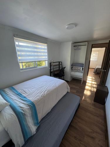 a bedroom with a large bed and a window at Casa Maybell in Chillán