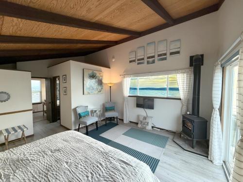 a bedroom with a bed and a large window at Bella Oceana in Dillon Beach