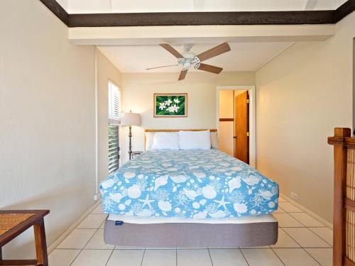 a bedroom with a bed and a ceiling fan at #04 Black Sand Beach Condo in Pahala