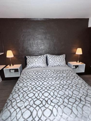 a bedroom with a large bed with two night stands at Private Studio in an Edwardian Town Home in San Francisco