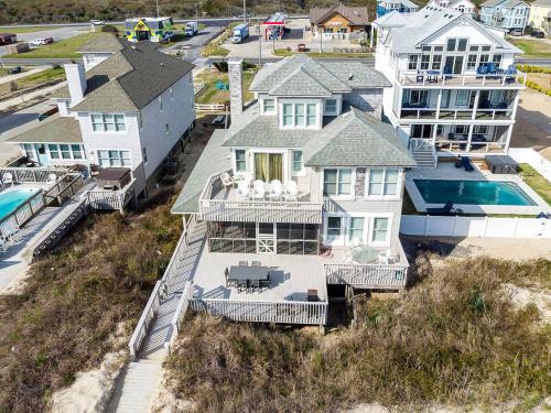 an aerial view of a house with a swimming pool at Looking Glass - Nags Head MP 12, Oceanfront, Ocean View, Pool, Hot Tub, Pets OK, Flex Stays in Nags Head