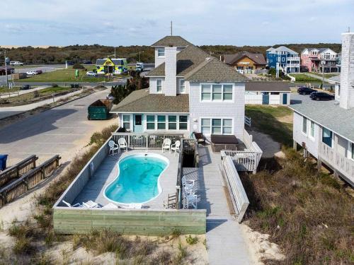 an aerial view of a house with a swimming pool at Sea Reunion - Nags Head MP 12.5, Oceanfront, Amazing Views! Pool, Hot Tub, Pets OK in Nags Head