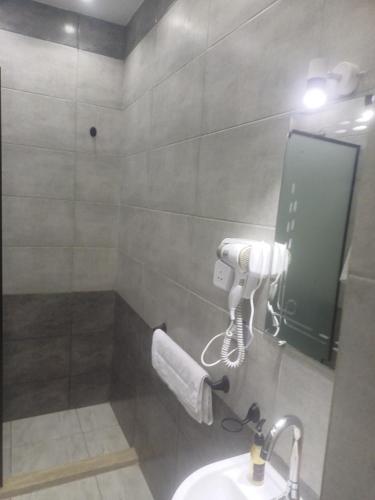 a bathroom with a sink and a mirror at Capital Hotel in Downtown in Cairo