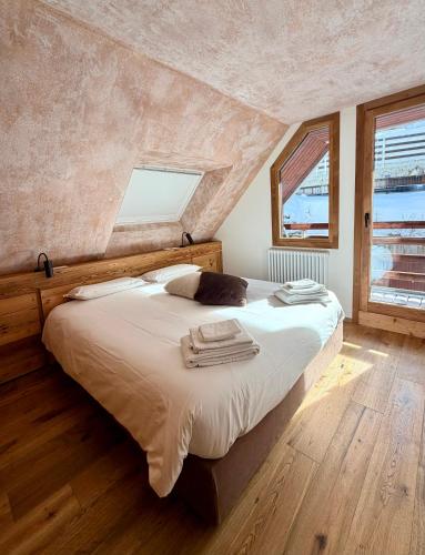 a bedroom with a bed with towels on it at Sky nest - Matterhorn in Breuil-Cervinia