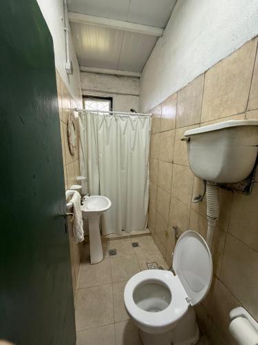 a small bathroom with a toilet and a sink at Viñedos del Este in San Juan