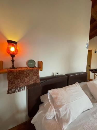 a bedroom with a bed with a lamp on the wall at Nof Harim נוף הרים in Even Menahem