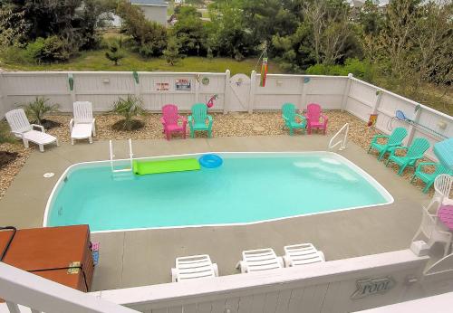 a large swimming pool with chairs and a pool table at Key to Paradise - Kitty Hawk MP 4, Pool, Hot Tub, Excellent Ocean View, Easy Beach Access in Kitty Hawk