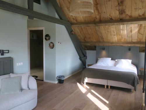 a bedroom with a bed and a couch at Hof van Kleeberg in Mechelen