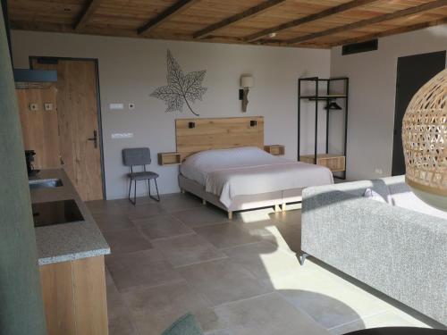 a bedroom with a bed and a couch in a room at Hof van Kleeberg in Mechelen