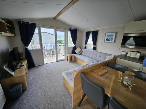 a living room with a couch and a table at Rendezvous at Ocean Edge in Heysham