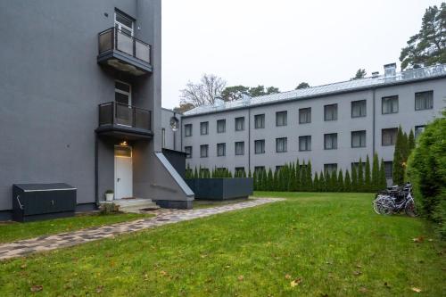 a building with a motorcycle parked in front of it at Beachside Studio with Private Garden & Terrace 100m to the beach in Jūrmala