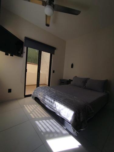 a bedroom with a bed and a large window at Día y noche in Guadalajara