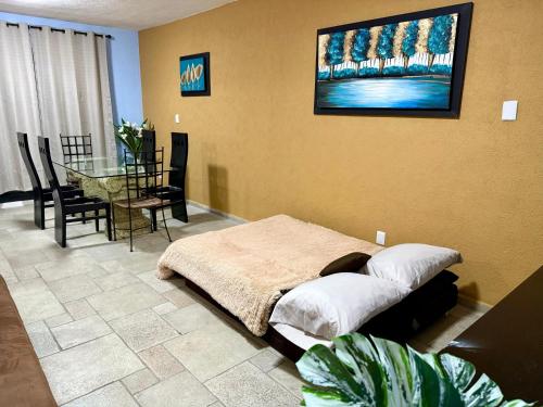 a bedroom with a bed and a table in it at Marina Diamante Plata D5 in Acapulco