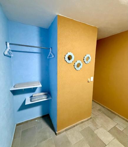 a room with blue and yellow walls and shelves at Marina Diamante Plata D5 in Acapulco