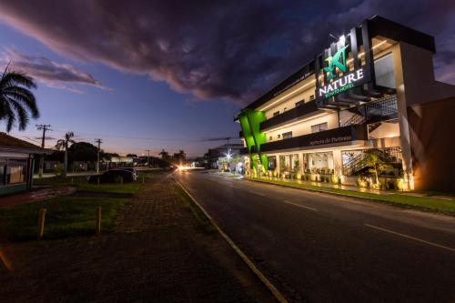 a building with green lights on the side of a street at Nature Bonito Hotel in Bonito