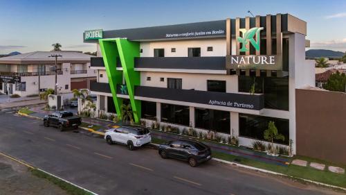 a building with cars parked in front of it at Nature Bonito Hotel in Bonito