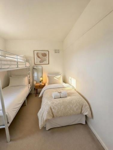 a bedroom with two beds and a bunk bed at Dreghorn House 5 b-rooms 9 beds 3 toilets 2 showers,1 bath 2 receiption Secure free Parking 233 Wifi in Edinburgh