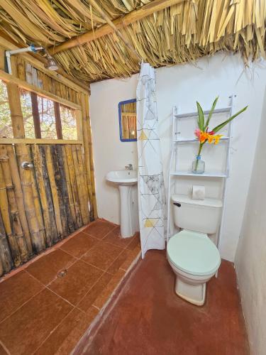 a bathroom with a toilet and a sink at Tyler's place in Coco