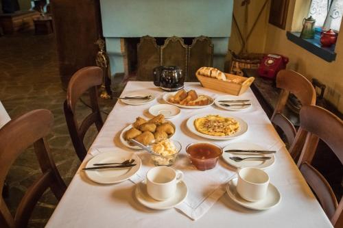 a table with breakfast foods and coffee on it at Petroto in Fragkades