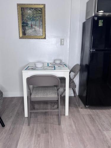 a white table with a chair and a black refrigerator at Private Studio in an Edwardian Town Home in San Francisco