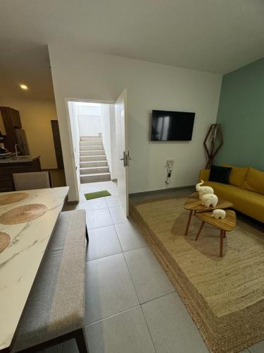 a living room with a couch and a table at El Departamento Playa Sur in Mazatlán