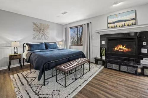 a bedroom with a king sized bed and a fireplace at Fall Season Mtn Views, Hot Tub, Sauna, close to Downtown! in Gatlinburg