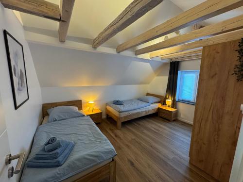 a bedroom with two beds and two lamps in it at Melem Apartments 2 in Langen