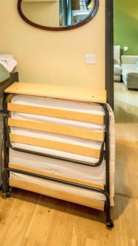 a dresser with a mirror on top of it at Summer Deals up to 20 Percent OFF! Cosy Central London Family Stay Near Top Attractions - London Bridge & Shard - 3 Nearby Stations & Parking - WiFi & Games! in London