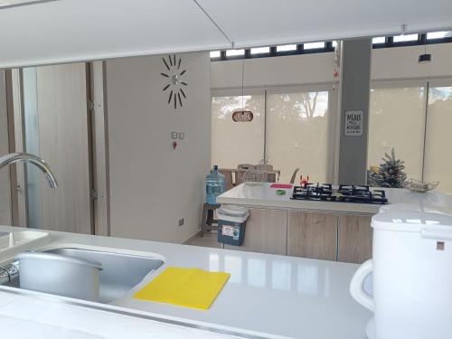 a kitchen with a sink and a mirror at Avemaría! in Puente Nacional