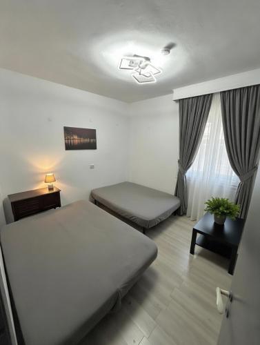 a hotel room with two beds and a window at Kjara's Nest in Neoi Epivates