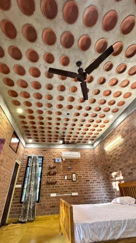 a room with a ceiling with a bed in it at AV Meadows in Kanchipuram