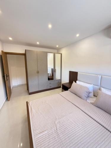 a bedroom with a large bed and a large mirror at Paradise Palms Vacation Rentals in Mīdān az Zīr