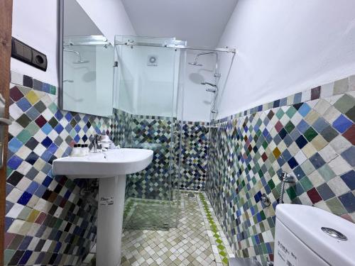 a bathroom with a sink and a shower at Riad Azul Fes & SPA in Fez