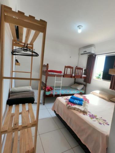 a room with two bunk beds and a ladder at Aconchego da Nina in Jijoca de Jericoacoara